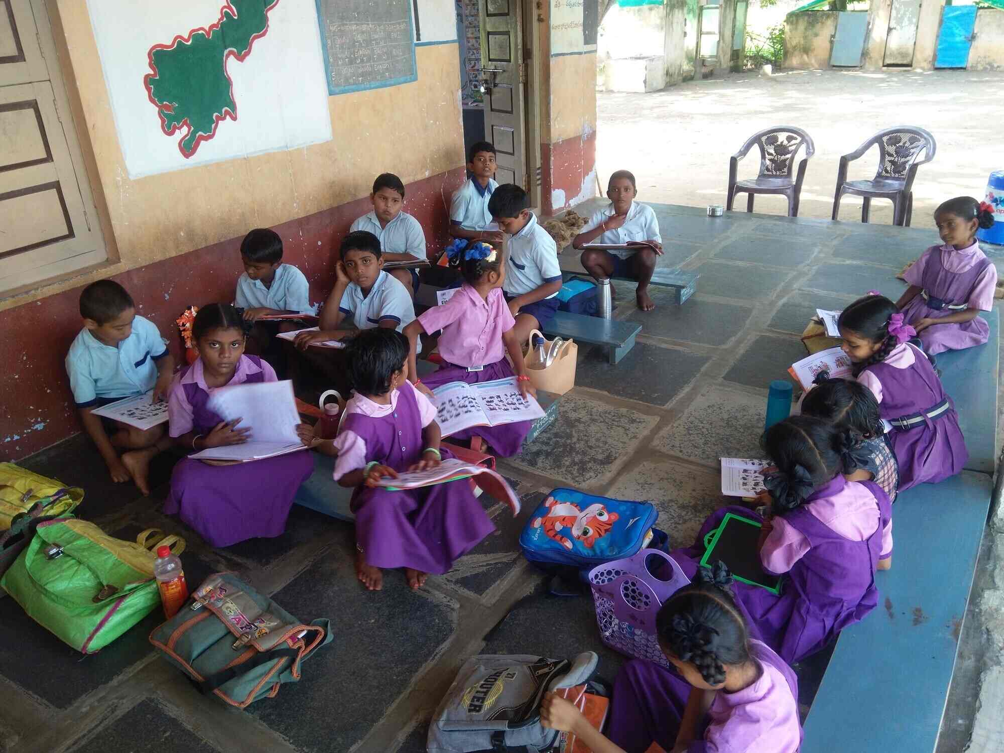 Students studying outdoors on the floor